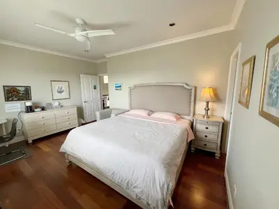 a bedroom with a bed and a ceiling fan at A cozy independent entrance bedroom with a private washroom close to YVR Richmond in Richmond
