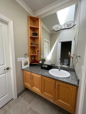 a bathroom with a sink and a mirror at A cozy independent entrance bedroom with a private washroom close to YVR Richmond in Richmond
