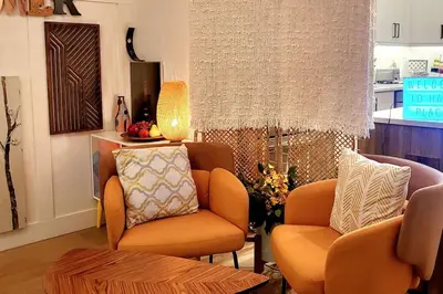 a living room with a couch and a chair at Welcome to Happy Place where Cozy Comfort Meets Exquisite Luxury in Edmonton