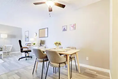 a dining room with a table and chairs at Roomy Top Floor at Stampede w Free Parking and AC in Calgary