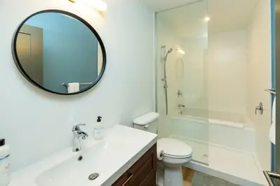 a white bathroom with a sink and a mirror at NN War Eagles Nest Ravens Ridge 1bed 1 bath in Whitehorse