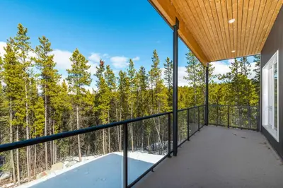 a balcony with a view of the woods at NN War Eagles Nest Ravens Ridge 1bed 1 bath in Whitehorse
