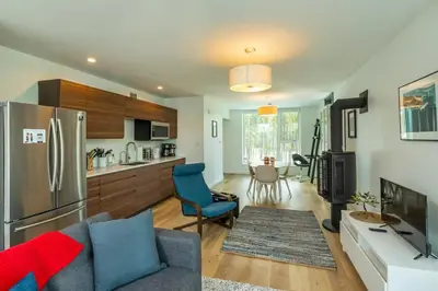 a kitchen and living room with a couch and a refrigerator at NN War Eagles Nest Ravens Ridge 1bed 1 bath in Whitehorse
