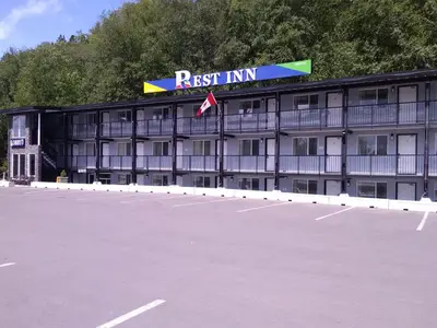 an empty parking lot in front of a hotel at Rest Inn in Terrace