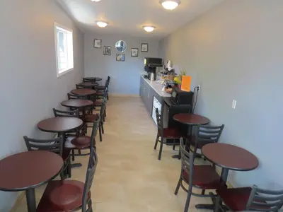 a row of tables and chairs in a restaurant at Rest Inn in Terrace