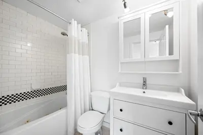 a white bathroom with a toilet and a sink at Alpenglow Lodge West Coast Wonder by MVA in Whistler