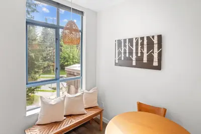 a room with a window and a bench with pillows at Alpenglow Lodge West Coast Wonder by MVA in Whistler