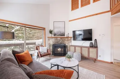 a living room with a couch and a fireplace at Powderview by Outpost Whistler in Whistler