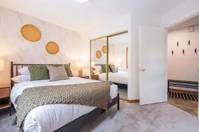 a bedroom with a bed and a mirror at Powderview by Outpost Whistler in Whistler