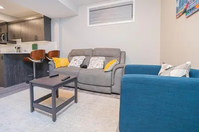 a living room with a couch and a table at Cozy Springs in Calgary