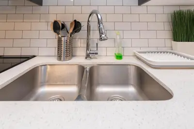 a stainless steel sink in a kitchen at Cozy Springs in Calgary