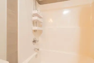 a bathroom with a shower and a bath tub at Cozy Springs in Calgary