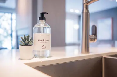 a bottle of hand soap sitting on a counter next to a sink at Gleneagles by Outpost Whistler in Whistler