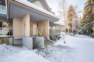 a house with snow on the ground in front of it at Gleneagles by Outpost Whistler in Whistler