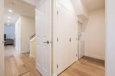 a hallway with white doors and wood floors at Lake Placid Lodge by Outpost Whistler in Whistler