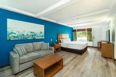 a living room with a bed and a couch at Quality Inn & Suites in Clearwater