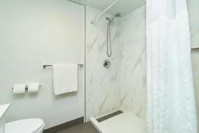 a bathroom with a shower and a toilet at Quality Inn & Suites in Clearwater