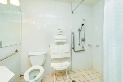 a bathroom with a toilet and a shower at Quality Inn & Suites in Clearwater