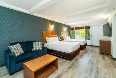 a hotel room with a bed and a couch at Quality Inn & Suites in Clearwater