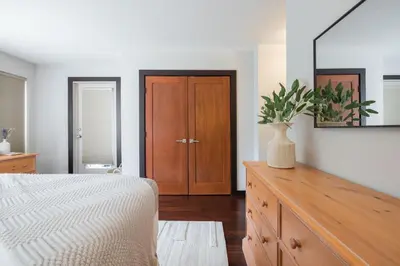 a bedroom with a bed and a dresser with a mirror at Greyhawk 123 by Outpost Whistler in Whistler