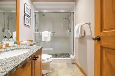a bathroom with a shower and a toilet and a sink at Mountain Star by Outpost Whistler in Whistler
