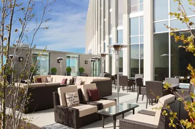 a patio with chairs and tables on a building at Grey Eagle Resort in Calgary