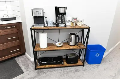 a shelf with a coffee maker on it in a kitchen at The Jade Place in Airdrie