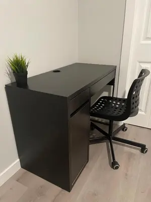 a black desk with a chair in a room at Private Chic Modern Suite with Kitchen near Spruce Meadows and LRT in Calgary