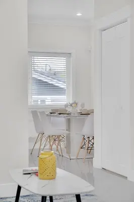 a white room with a table with a cake on it at Family-Friendly, 3 Bed House - Private Backyard-Central Location in Vancouver