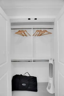 a room with a closet with hangers and a bag at Family-Friendly, 3 Bed House - Private Backyard-Central Location in Vancouver