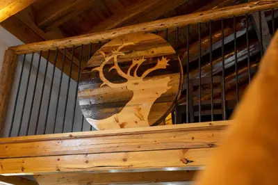 a wooden bird cage with a vase on it at Red Cariboo Resort in Anahim Lake