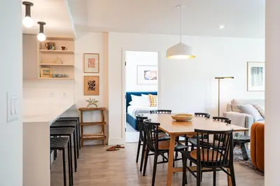 a dining room and living room with a table and chairs at Sea Eagles Landing by Revelstoke Vacations in Revelstoke