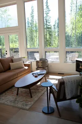 a living room with a couch and a table at Luxury Private Cabin In The Rockies in Golden