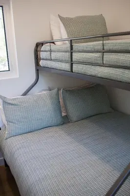 a bunk bed with two pillows and towels at Luxury Private Cabin In The Rockies in Golden