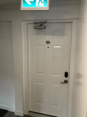 a white door in a room with a sign above it at Unit #204 Cozy Mountain View 2BR in Canmore Downtown in Canmore