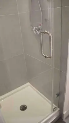 a shower with a glass door and a mirror at Newly Renovated Walkout Basement in Vancouver with Separate Entrance in Vancouver