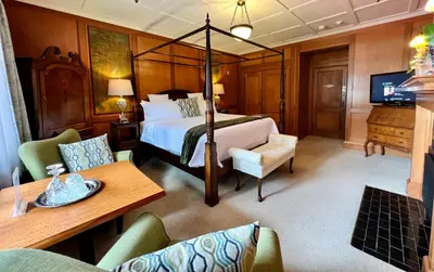 a hotel room with a bed and a table and chairs at The Latch Inn in Sidney