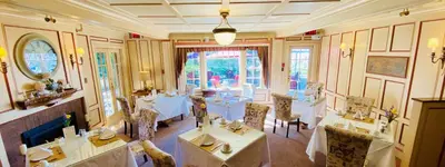 a restaurant with tables and chairs in a room at The Latch Inn in Sidney