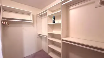 a walk in closet with white walls and a door at Master Bedroom with Two Queen Sized Bed in Richmond