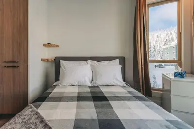 a bedroom with a bed and a window with a view at The Fjall Ski-In Ski-Out Village Studio in Big White