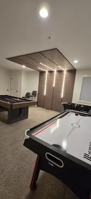 a room with a ping pong table and pool tables at Mountain Retreat with Views, Hot Tub, Games & AC in Chilliwack