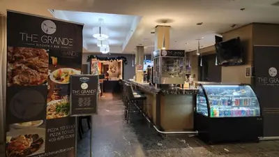 a restaurant with a counter and a bar with food at Luxury 2 Bedroom 1Pullout Kitchenette Grand Rockies Resort Hot Tub Pool Mountain View in Canmore
