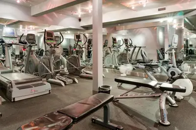 a gym with a lot of cardio equipment in it at Luxury 2 Bedroom 1Pullout Kitchenette Grand Rockies Resort Hot Tub Pool Mountain View in Canmore