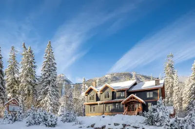 a house in the snow with snow covered trees at Copper Horse Lodge in Golden