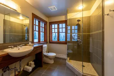 a bathroom with a sink toilet and a shower at Copper Horse Lodge in Golden