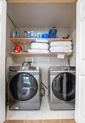 a laundry room with two washing machines and towels at R&R Relaxation Ridge, Private Hot Tub, Spacious in Radium Hot Springs