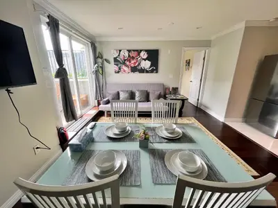 a living room with a table and chairs and a couch at Coze home in Vancouver near YVR in Vancouver