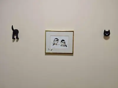 a picture of two birds and a cat on a wall at sweet home in Richmond