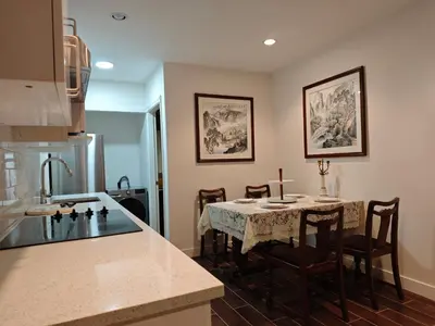 a kitchen with a table and chairs in a room at sweet home in Richmond