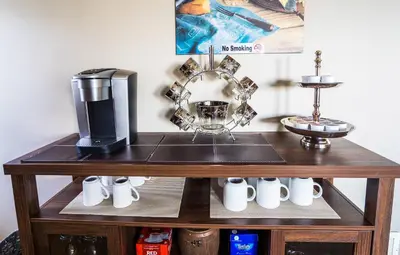 a wooden table with a coffee maker and a blender at Sunrise Valley Suite in West Kelowna